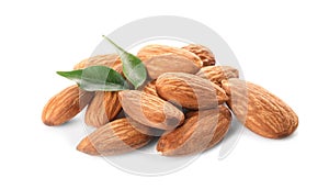 Organic almond nuts and leaves on white background