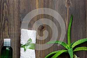 Organic aloe vera cosmetics. Aloe vera leafs, glass of aloe vera juice on wooden table background top view copyspace