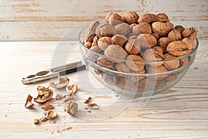 Organic autumn walnuts in a bowl, whole and cracked, healthy brain food with vitamins, unsaturated fatty acids and antioxidants,