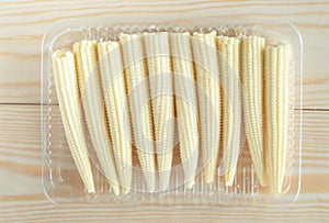 Organic baby corn in plastic container