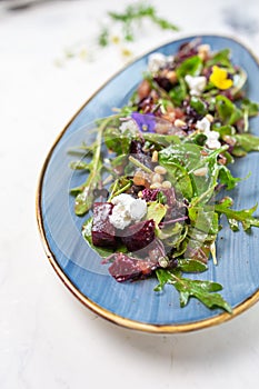 Organic baby greens salad with beets, goat cheese, pistachios, citrus dressing