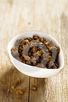 Organic bee polen in a white bowl