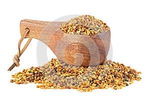 Organic bee pollen in wooden spoon isolated on white background, healthy food supplements. Dried healthy natural honey bee