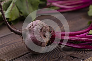 Organic Beetroot,red beetroot with herbage green leaves on rustic background.