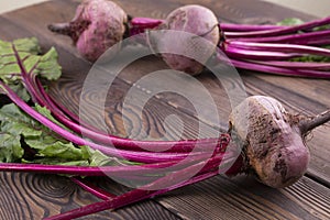 Organic Beetroot,red beetroot with herbage green leaves on rustic background