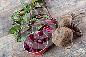 Organic beetroots with salad on wooden background