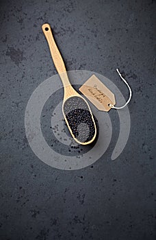 Organic Beluga lentils on a measuring spoon