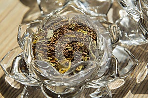 Organic black Chai tea in a glass lotus flower bowl