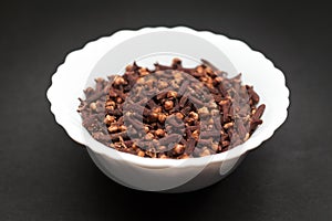 Organic black clove in ceramic bowl.