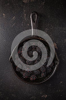 Organic blackberries in baking forms, ripe blackberries