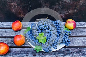 Organic blue grapes with peaches, prepared for the buffet table