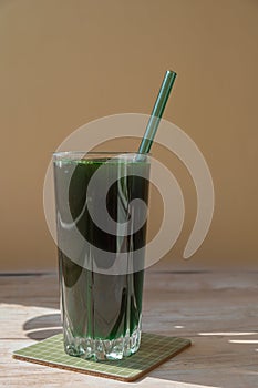 Organic blue-green algae spirulina detox drink in glass powder food. Health protein cocktail smoothie of chlorella