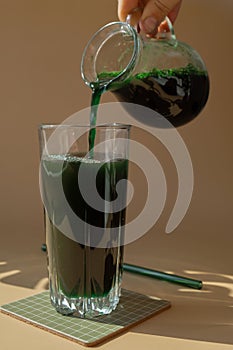 Organic blue-green algae spirulina detox drink in glass powder food. Health protein cocktail smoothie of chlorella