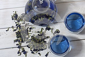 Organic blue tea Anchan, Clitoria, Butterfly Pea in glass teapot with glass cups