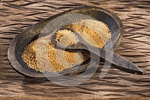 Organic brown sugar in the wooden bowl - Saccharum officinarum