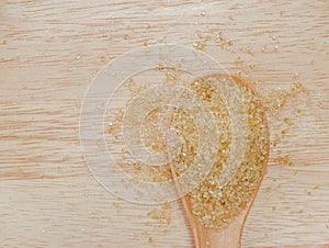 Organic brown sugar in wooden spoon.