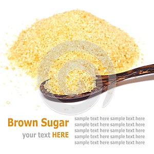 Organic brown sugar and wooden spoon isolated