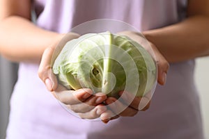 Organic cabbage holding by woman hand