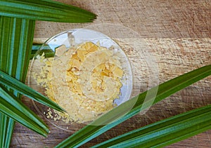 Organic Carnauba Wax comes in the form of hard yellow flakes and is widely used in cosmetics as an emulsifier or as a thickening