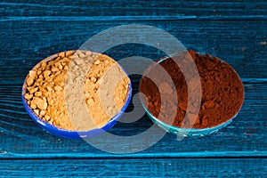 Organic carob and cacao powder in bowls. Natural cocoa substitute.