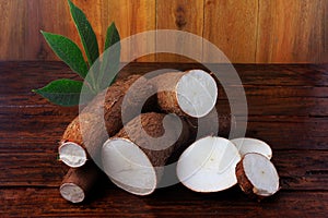 Organic cassava mandioca, aipim, brazilian cuisine, fresh and raw on rustic wooden table photo