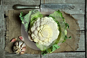 Organic cauliflower and garlic on a vintage background