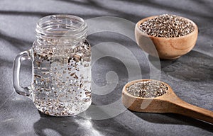 Organic chia seeds and glass of filtered water - Salvia hispÃÂ¡nica photo