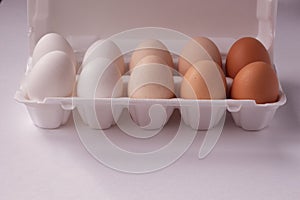 Organic chicken eggs of different colors in an egg box. Eggs from different breeds of chickens