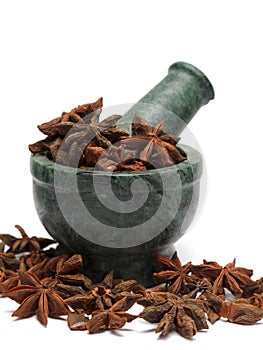 Organic Chinese Star Anise ( Illicium verum) on marble pestle