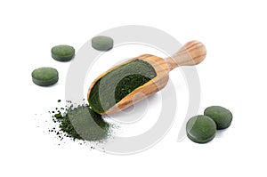 Organic chlorella and spirulina powder and pills in a wooden scoop isolated on white