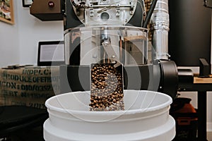 Organic Coffee Beans Roasting in an Industrial Coffee Bean Roaster and Cooling on Mechanical Stirring Pan