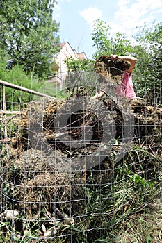 Organic composter. People are making bio composter bin in a yard