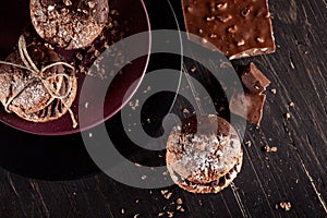 Organic cookies with pieces of chocolate on old wooden background