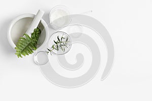 Organic cosmetic product, natural ingredients and laboratory glassware on white background, flat lay. Space for text