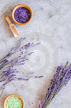 Cosmetic set with lavender herbs and sea salt in bowl on stone table background flat lay mockup