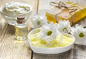 Organic cosmetics with camomile extract on wooden table background