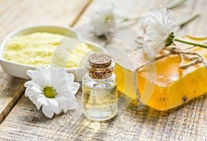 Organic cosmetics with camomile extract on wooden table background