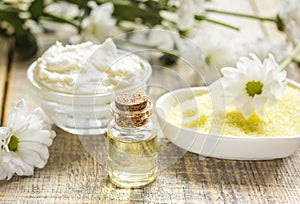 Organic cosmetics with camomile extract on wooden table background