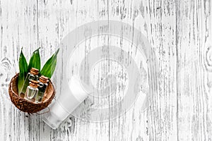 Organic cosmetics with coconut. Coconut cream and lotion on wooden background top view copyspace