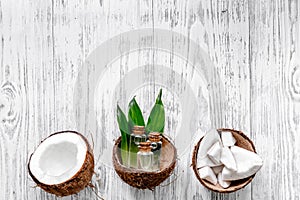 Organic cosmetics with coconut. Coconut lotion on wooden background top view copyspace