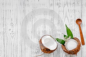 Organic cosmetics with coconut. Coconut oil on wooden background top view copyspace