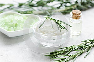Organic cosmetics with rosemary extract on stone table background