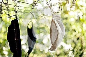 Organic Cotton Face Mask Hanging on Clothesline. Fabric Washable Mask after Wash Cleaning