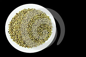 organic dried hemp seeds in a plate on a black background
