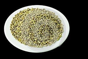 organic dried hemp seeds on a white plate