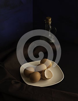 Brown eggs and broken eggshell of the plate.