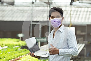 Organic farmer stands a great thumbs up