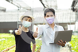 Organic farmer stands a great thumbs up