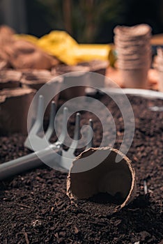 Organic farming rake and pots in soil