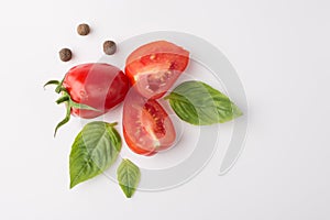 Organic food eating concept. Top above overhead view photo of tomatoes spices and baby spinach isolated on white background